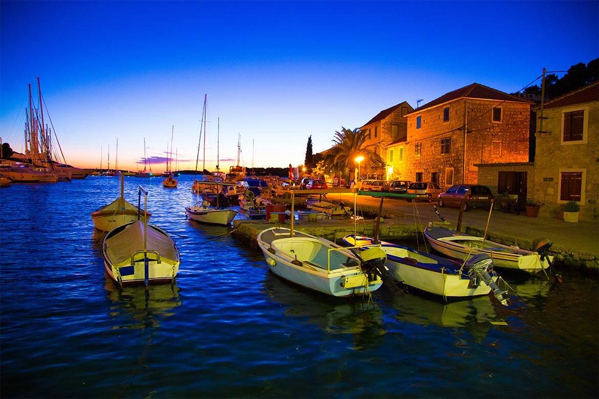 A marina with small boats in Croatia after sundown